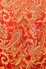 texture of bright red fabric with cucumbers