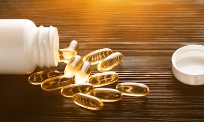 Fish Oil Capsules on wooden table