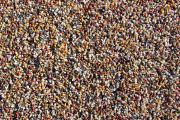Red, yellow, white and grey gravel wall decoration surface texture close up