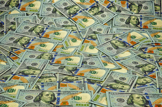 Lot of one hundred dollar bills close-up background
