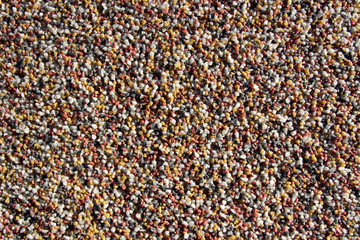 Red, yellow, white and grey gravel wall decoration surface texture close up