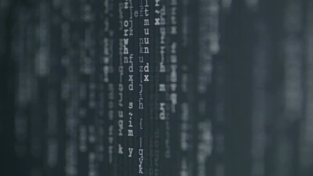 Abstract computer code flowing on a screen. Extreme closeup footage with follow focus.