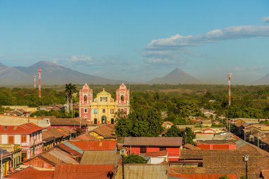 A view over the terracotta rooftops, of the colourful church of El Calvario, Leon, Nicaragua