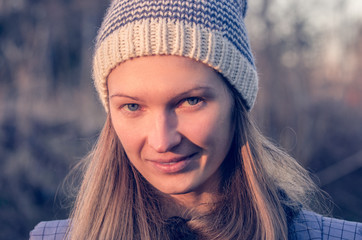 Portrait of an attractive blonde woman in a knitted hat