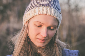 Portrait of an attractive blonde woman in a knitted hat