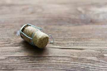 Fototapeta na wymiar champagne cork on wooden background