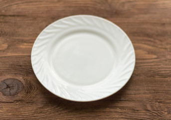 empty white plate on wooden background