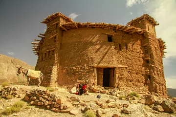  View of an old house in the countryside landscape in Morocco on a sunny day. Aitbougamaz, azilal, morocco © yassine