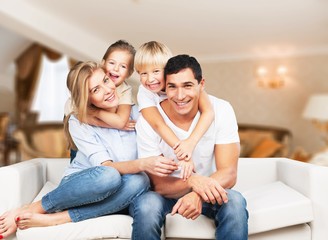 Young  family at home smiling at camera