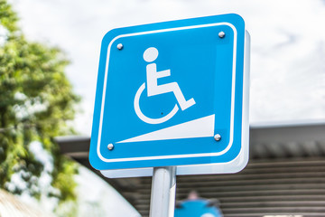 Blue Handicap at parking car sign outdoors for Disabled, Wheelchair or elder old or cannot self help people