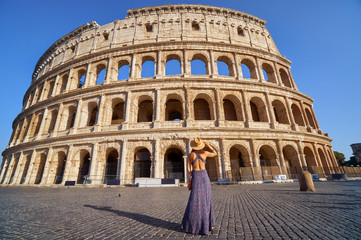 Fototapeta na wymiar Colosseum and young tourist woman near gladiator arena famous ancient historical roman empire architecture landmark stone ruin amphitheater monument