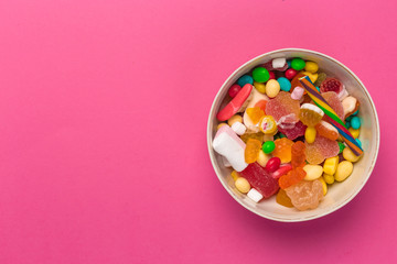 Fototapeta na wymiar Colorful lollipops on a pink background