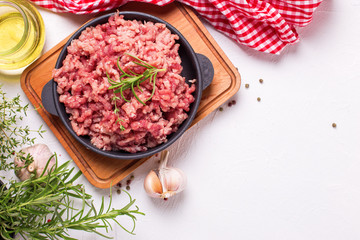 Raw minced meat in bowl  with ingredients for cooking - obrazy, fototapety, plakaty