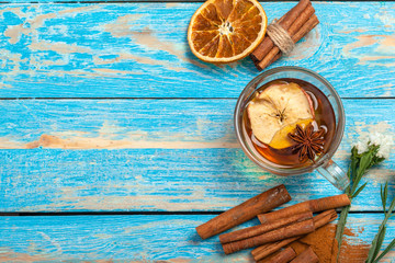 Cup with aromatic hot cinnamon tea on wooden table