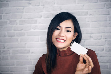 Asian girl raise white cards and good .Focus on face