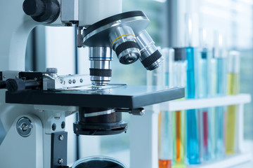 Microscope with test tubes at the laboratory