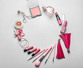 Composition with decorative cosmetics and accessories on grey background