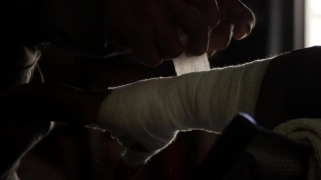 Boxer getting hand wrap by trainer in slow-motion