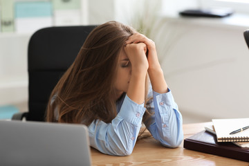 Upset young woman in office