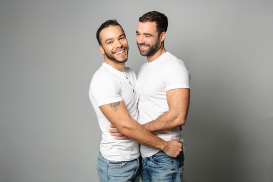 Homosexual Couple Over A White Background On Studio