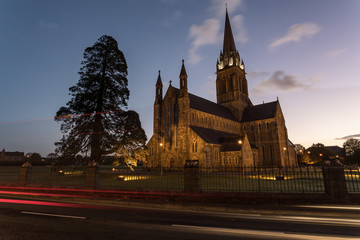 St. Mary's Cathedral in killarney during dawn sunrise, Car light streaks diving by