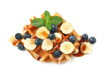 Tasty waffle with fruit, berries and topping on white background
