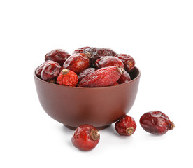 Bowl with rose hips on white background