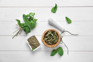 Composition with dried mint on white wooden background, top view