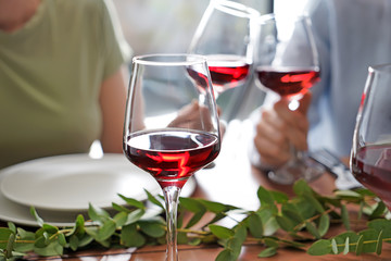 Glass of red wine on table set for party