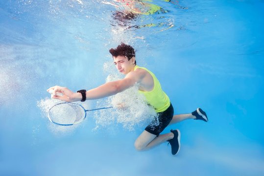 Teen plays badminton underwater, Ukraine, Europe