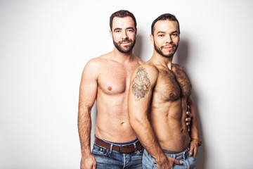 Fototapeta na wymiar Young homosexuals gay couple love each other on a white background.