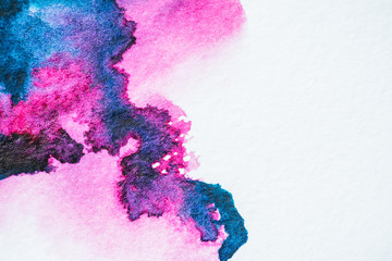 pink and purple watercolor blots on white paper texture