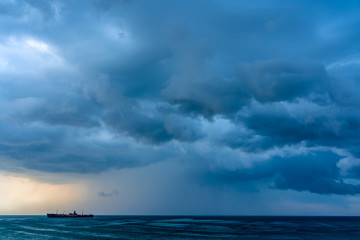 Naklejka na ściany i meble Storm Clouds Gathering Over Shipwreck Ocean