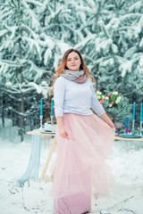 Beautiful girl on the background of the winter forest.