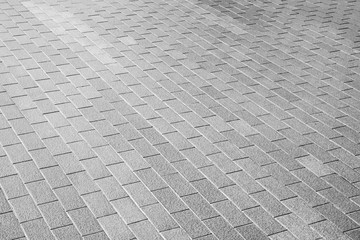patterned paving tiles, ceramic brick floor background - monochrome