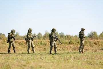 group of soldiers on the Outdoor on army exercises. war, army, technology and people concept