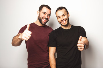 Young homosexuals gay couple love each other on a white background.