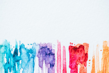 abstract colorful watercolor strokes on white paper background