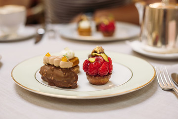 Different Kind of Small Cakes on the Plate, Traditional English Tea Ceremony in Luxury Hotel