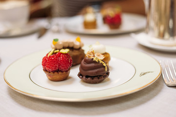 Different Kind of Small Cakes on the Plate, Traditional English Tea Ceremony in Luxury Hotel