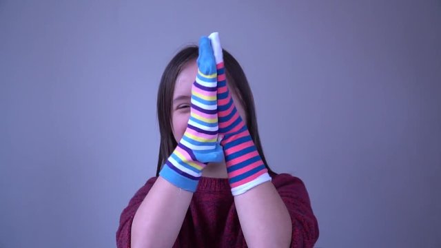 Girl with Down Syndrome have fun with different socks