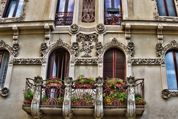 Fototapeta na wymiar facade of old house style art nouveau in Italy, floristic ornaments in architecture
