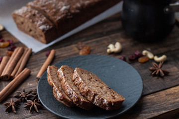 Homemade banana bread with anis star and cinnamon on a dark wooden background