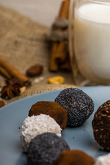 Candy and biscuit on a blue plate. Sweets on the fabric. A glass of milk