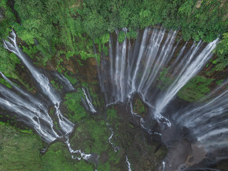 Stunning drone view of Coban Sewu waterfall in Java, Indonesia