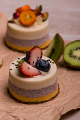 Cake with fruits and berries close-up. White dessert on a wooden table. Cupcake.