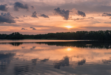 Fototapeta na wymiar Paurotis Pond in Everglades National Park, Florida, USA - July 16, 2018: Sunset and reflections at Paurotis Pond in the Everglades National Park near Homestead, Florida