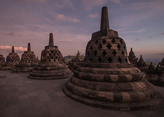 Stuppas and sunrise colors at the ancient Borobudur Temple in East Java, Indonesia