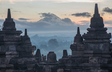 Clouds rolling over Mount Merapi viewed from the Borobudur Temple ruins in East Java, Indonesia