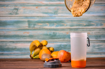 Fruits and Vegetables are blended up into a healthy smoothie and in the process of pouring into a...